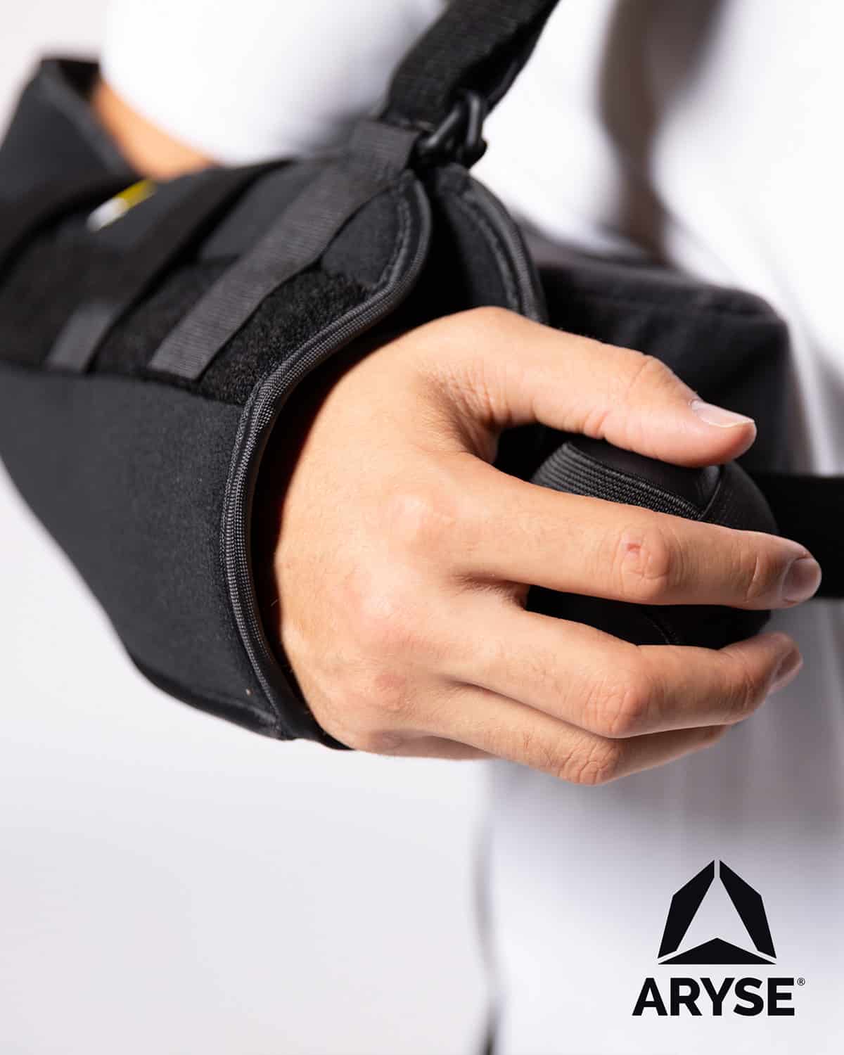 A person holding a black ARYSE METFORCE SHOULDER.