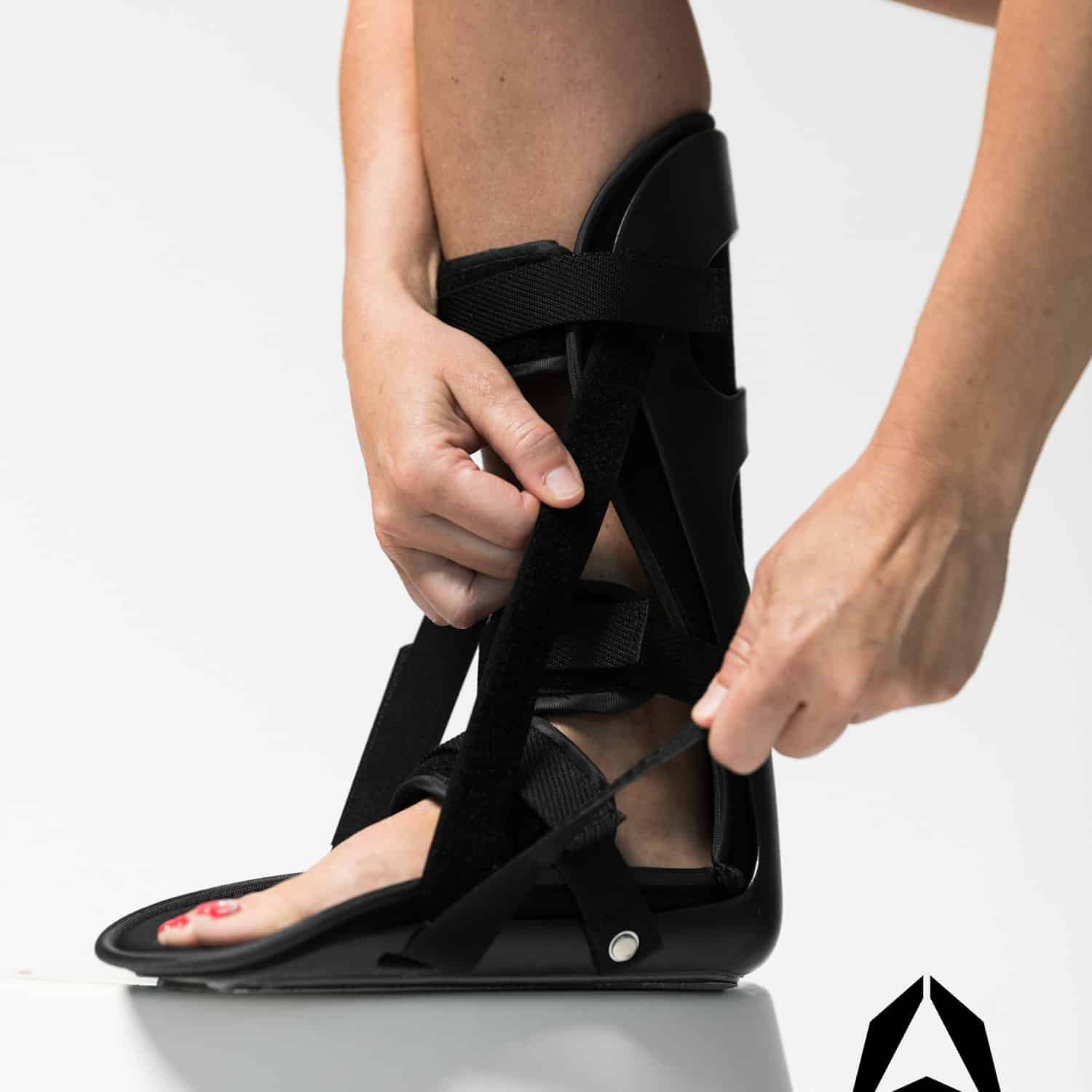 A woman is putting on a LUNAR® LEVEL ankle brace from her medical supply.